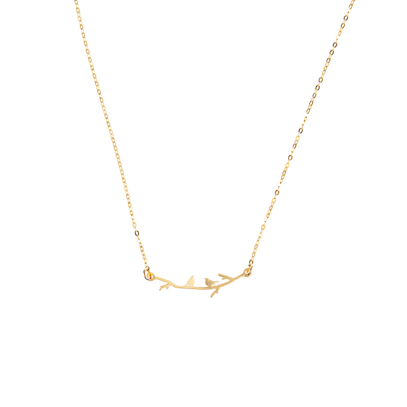 Two tiny, silhouetted birds sit atop a delicate branch on this sweet, dainty necklace. This necklace is the perfect gift for anyone who loves nature or all things aviary. Wear it as a unique statement piece to elevate your look. Gold-filled chain Chain length: 16" (including branch detail).