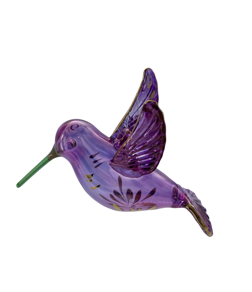 Brightly colored and mesmerizing, hummingbirds are some of the most interesting of the over 18,000 bird species in the world. This glass ornament captures the delicate and fascinating hummingbird beautifully. Easy to hang; includes metallic gold cord. Size approx 4" x 3".