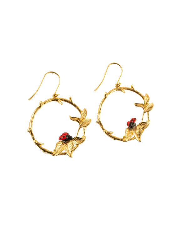 Carry the essence of a summer garden with you at all times with these delightful ladybug hoop earrings. Made from durable porcelain and 24K gold plated brass, these hoops are adorned with golden leaves and bright scarlet ladybugs, which are painted by hand, making each pair unique. Hoop diameter: 1.2". Limited edition.