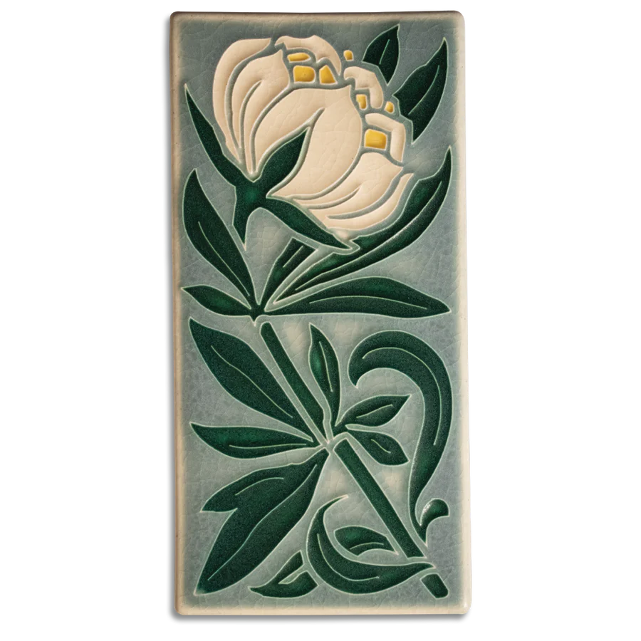 Beautiful, high quality decorative tile from ceramist, Motawi Tileworks. This tile depicts a cream-colored Peony in full bloom against a misty blue-grey background.  Size: 3 7/8” x 7 7/8”. As each tile is crafted by hand, dimensions may vary by up to 1/16". Tiles are 5/8" thick and have a notch at the back for hanging.
