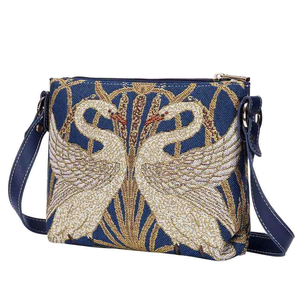 This elegant tapestry pattern is inspired by Walter Crane, a British painter. It depicts two swans facing each other, profiled in perfect symmetry. This crossbody bag is ideal for your daily essentials and can be worn as a crossbody or converted into a handbag or shoulder style bag. 10" x 8 ".
