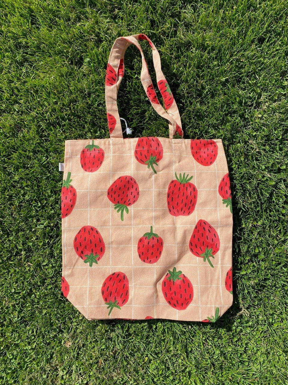 The perfect sized tote in which to carry your everyday essentials, whether that's your laptop, groceries, yoga kit and more! Features the sweetest, summery strawberry print. 100% cotton 14" x 15" x 4".
