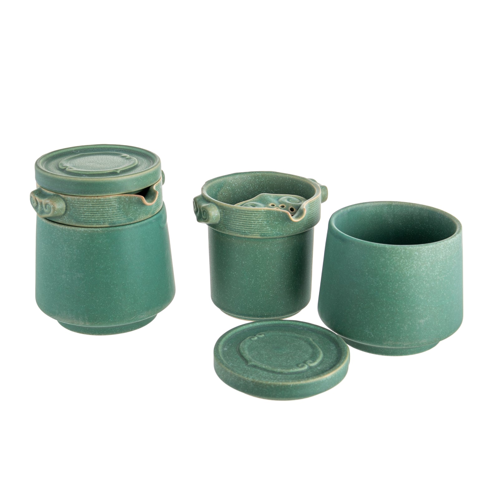 A set of emerald green ceramic tea infuser, cup, and lid.