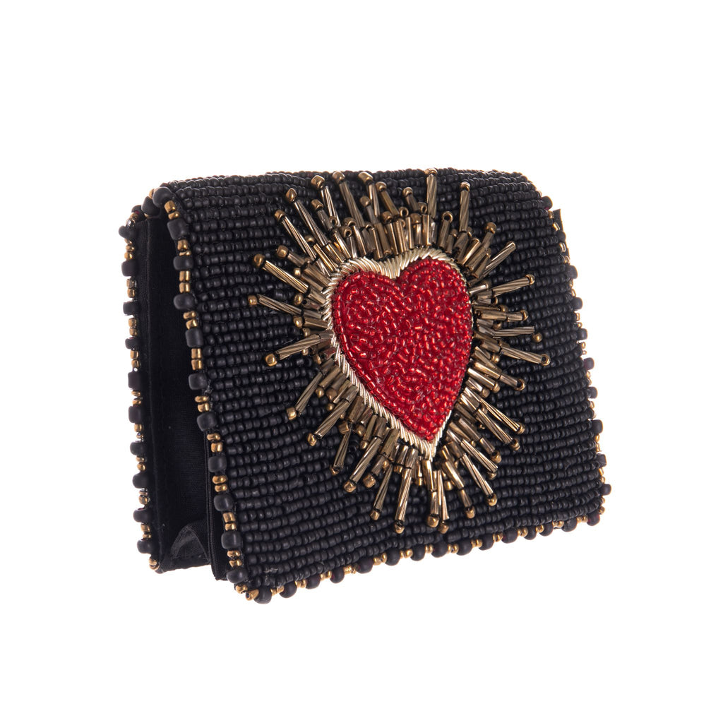 This intricately beaded 'affection' heart wallet is perfectly petite in size with plenty of features for cards, coins and cash. Features a beautiful red heart burst on a striking black base that you're sure to love. 4.375 x 1 x 3.25" Magnet closure. This is a handmade item.