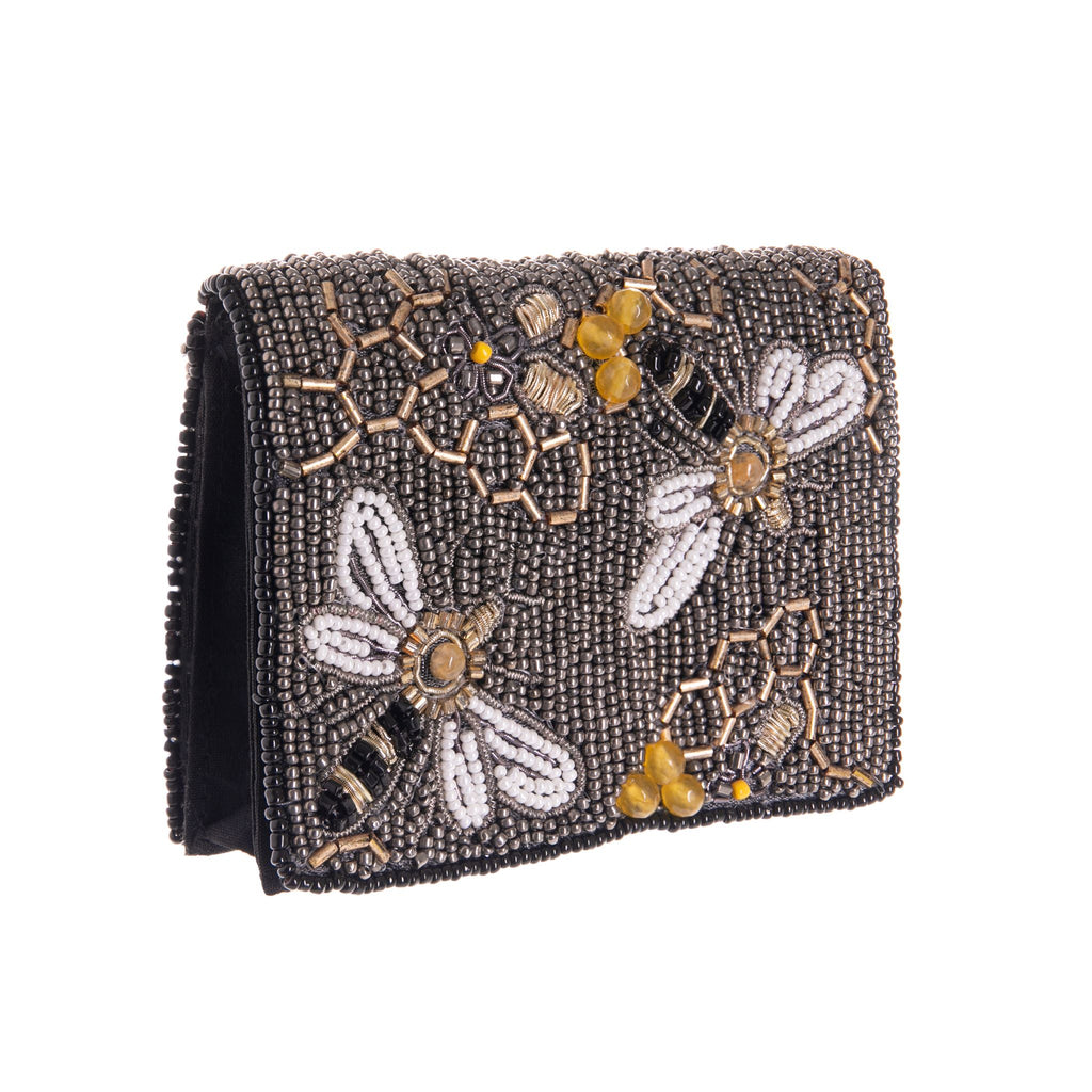 This exquisitely detailed 'Bee Awesome' wallet is perfectly petite in size with plenty of features for cards, coins and cash. Each style features a secure magnetic closure, a clear id window slot, and two individual card slots. Bee Awesome features a buzzy bee design on a pewter beaded base. Magnet closure. Handmade.