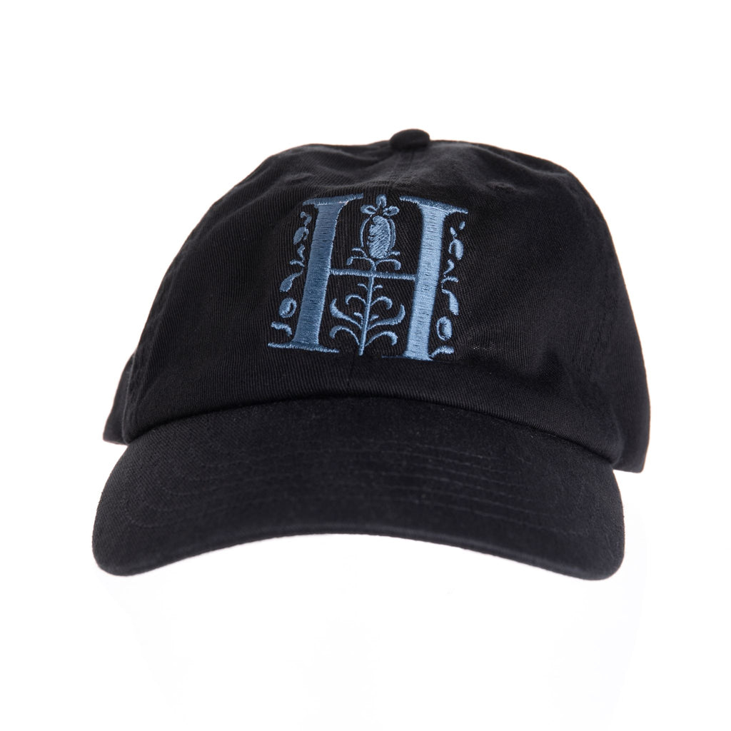Black baseball hat with steel blue embroidered Huntington H logo. One Size 100% Cotton Features The Huntington's iconic 'H' logo Exclusive to The Huntington