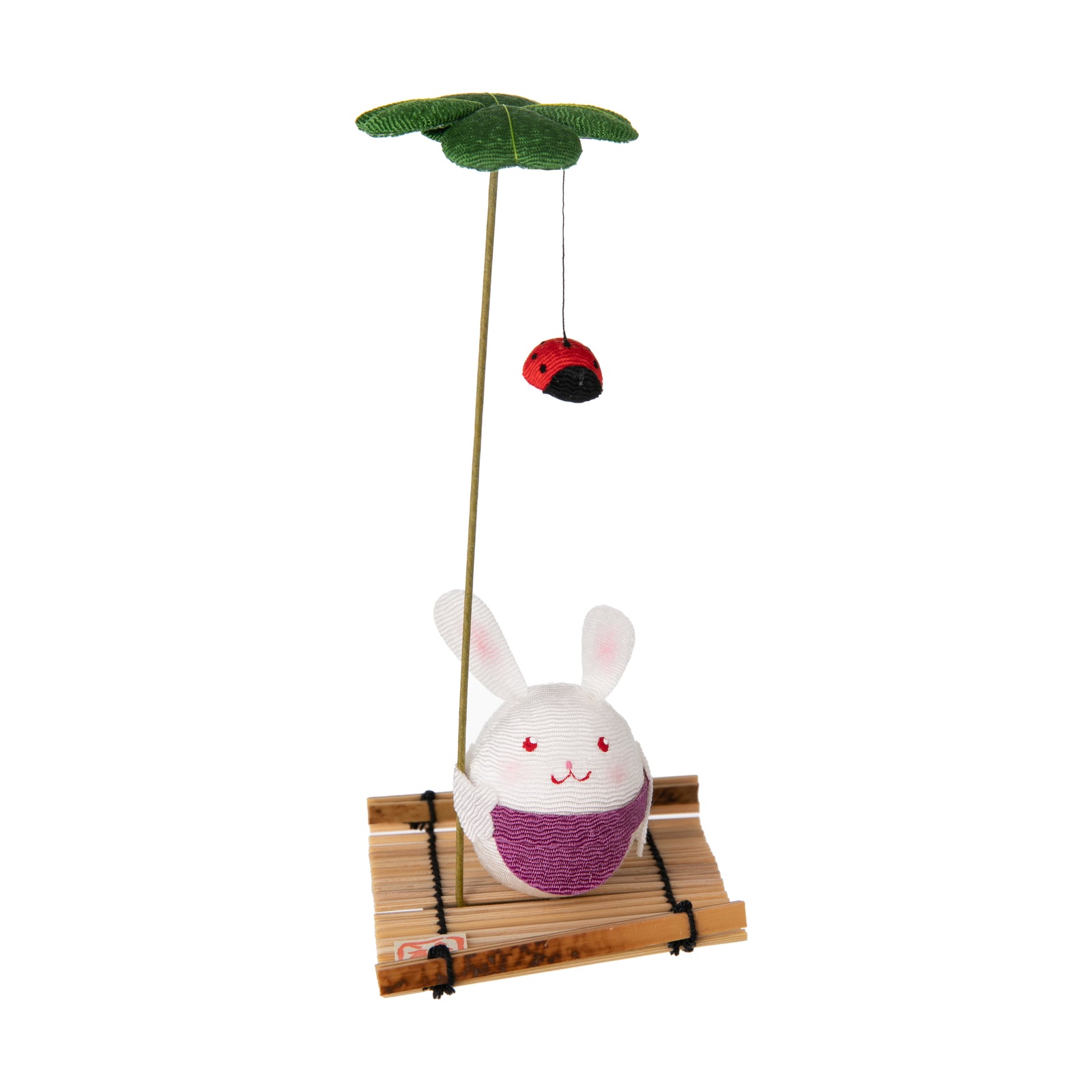 These cute figurines are a traditional Japanese lucky charm, often given or received during the Sakura or Cherry Blossom season. Made from chirimen fabric - traditional Japanese crepe silk. This figure depicts a spring bunny sitting on a tatami mat holding a lucky four-leaf clover and ladybug. Size approx 5" x 2.5"