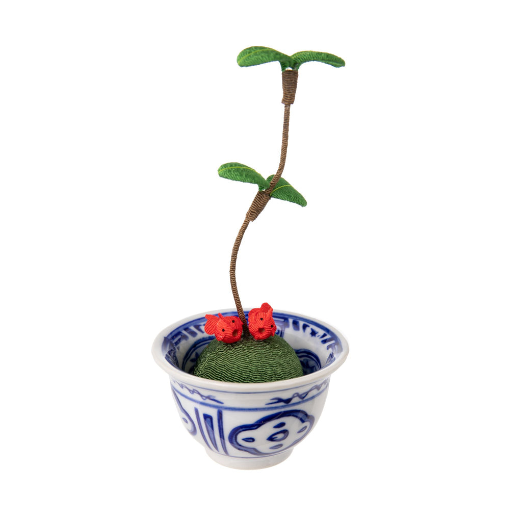 These cute figurines are a traditional Japanese lucky charm. Made from chirimen fabric - Japanese crepe silk which is commonly used to make Kimonos. This figure depicts two golden fish sitting on a kokedama moss ball, which has freshly sprouted! The kokedama sits in a blue and white china bowl.  Size approx 5" x 2."