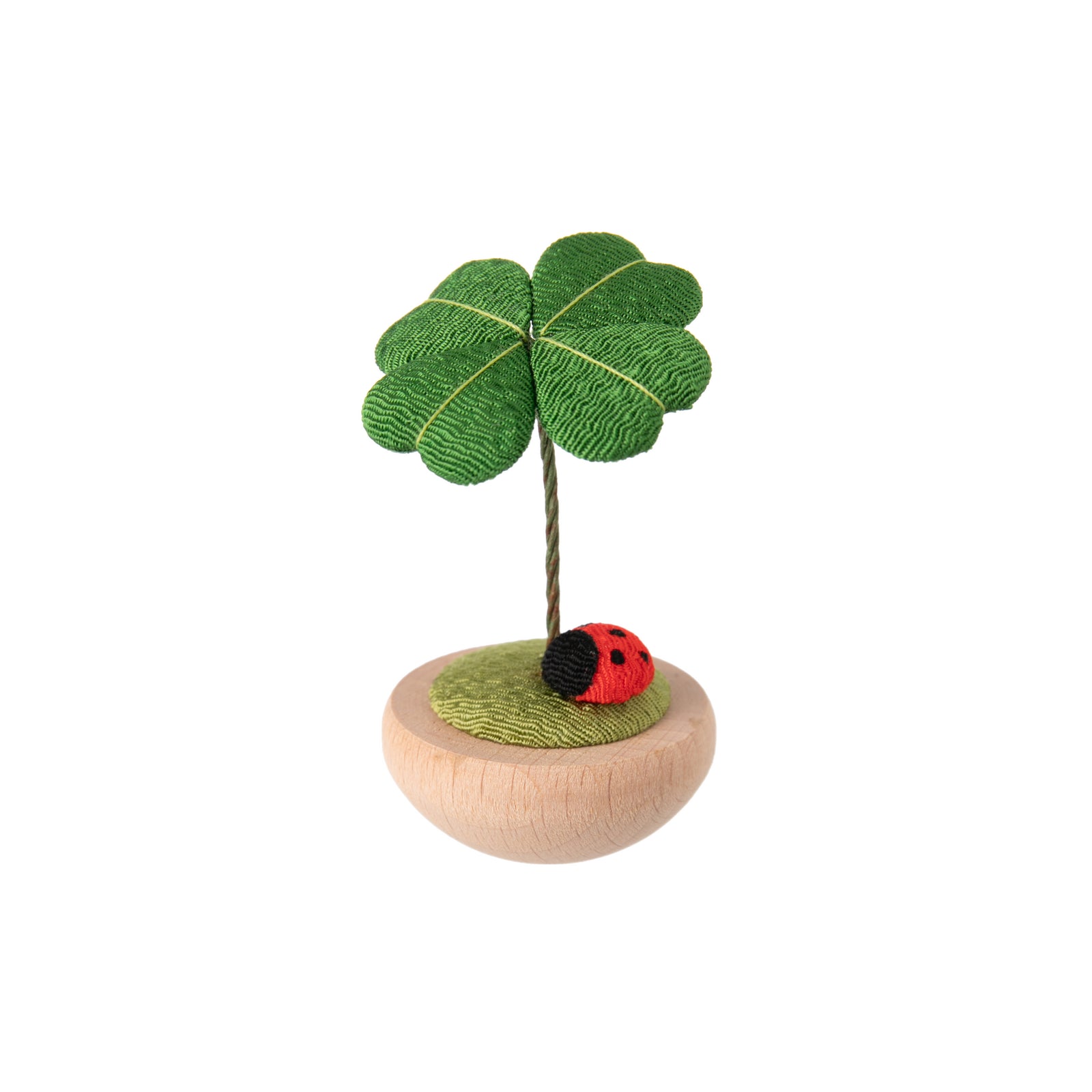 These cute figurines are a traditional Japanese lucky charm, often given or received during the Sakura or Cherry Blossom season. Made from chirimen fabric - traditional Japanese crepe silk, commonly used to make Kimonos. This figure depicts a ladybug sitting under a four-leaf clover, with a wood base. Size 2.5"x 2".