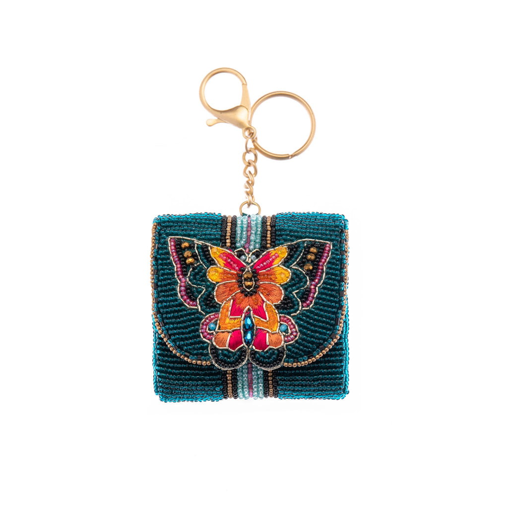 Never misplace your earbuds again with this beaded, butterfly earbud case. Features a secure magnet closure, keyring and clip for easy attachment to any handbag or belt loop. Lined with cotton and real leather sides to ensure your earbuds are kept safe, clean, and within easy reach. Size: 2.75" x 1" x 2.5' Handmade.