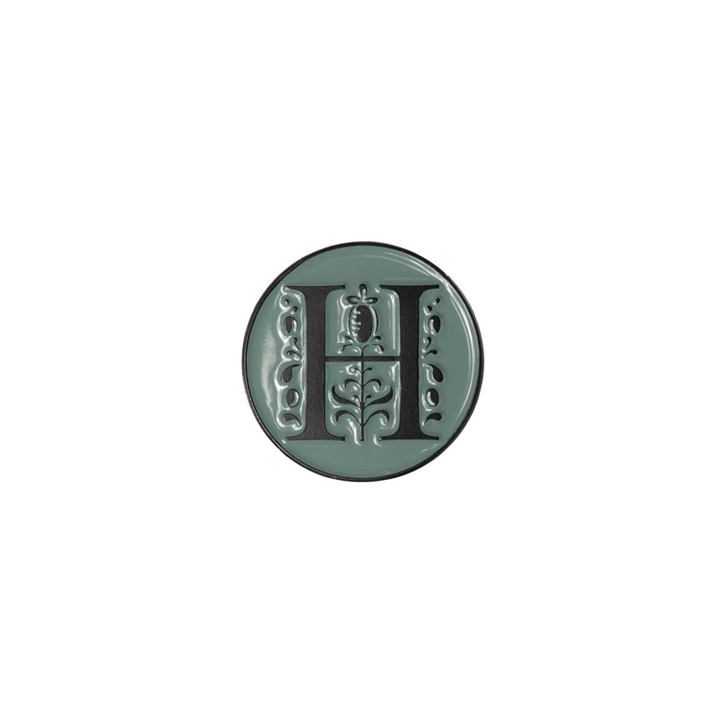 Enamel pin featuring the iconic Huntington 'H' logo. The H logo incorporates elements of the famous Huntington Entrance Gates. Size approx 1" diameter Exclusive to the Huntington Store.