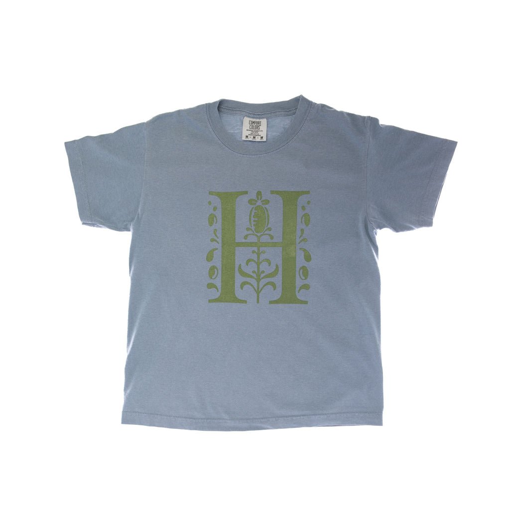 Pale blue unisex kids tee with green printed signature 'H' logo. 100% cotton Machine Washable. Huntington Store exclusive.