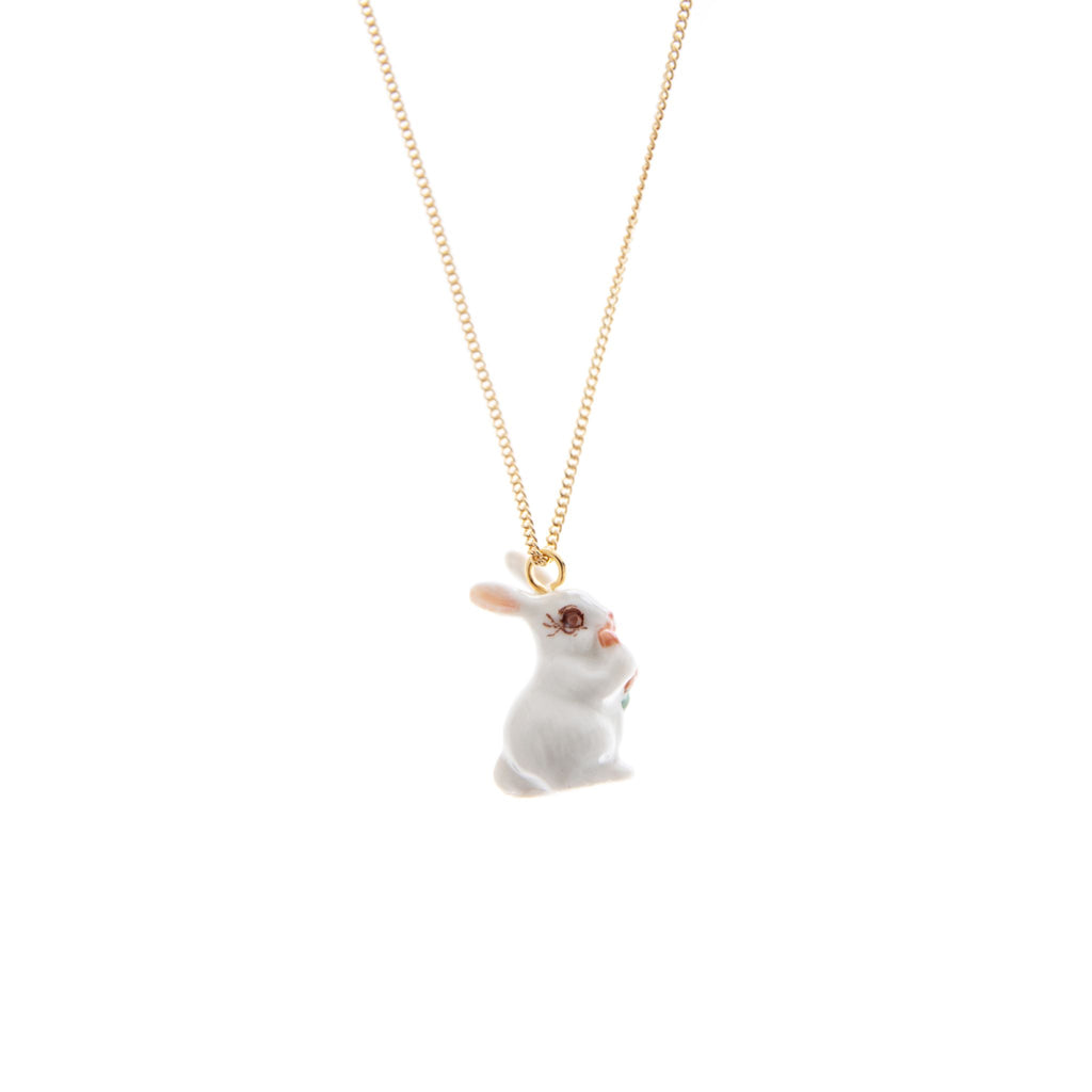 Keep a touch of springtime with you year-round with this adorable white rabbit necklace. Features a hand-painted porcelain bunny on a 24 carat gold plated chain. Porcelain and 24 carat gold plated over brass. Metal certified nickel free and allergy free. Chain length 19" Matching earrings available