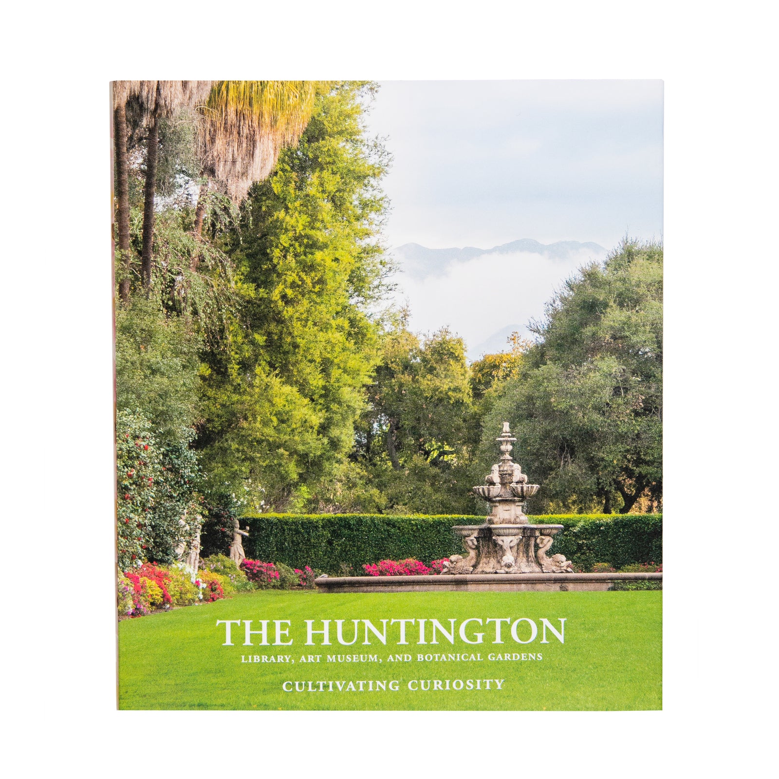 Cover of a book titled 'The Huntington Library, Art Collections and Botanical Gardens: Cultivating Curiosity', featuring an image of a garden with a fountain and lush greenery.
