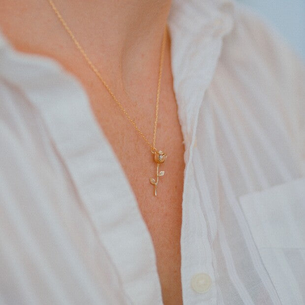 This delicate necklace has a slim stem rose pendant on a fine chain, finished with a lobster clasp fastening. Wear this piece with other pendant necklaces for a gorgeous, layered look. Chain length - can be worn at 40.5cm (16") or 45.5cm (18") Pendant - width 7mm x height 25mm x depth 5mm. 18ct gold plated brass.