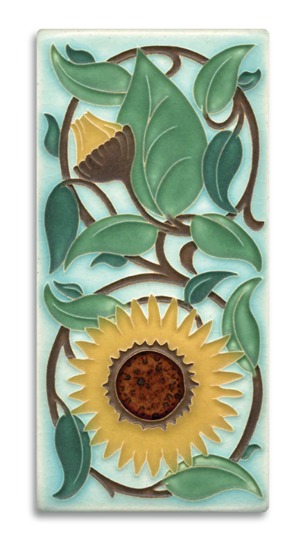 English artist William DeMorgan created tiles that were dust-pressed flats, the designs looking like charcoal sketches overlain with watercolor paintings. While a very different technique from Motawi's own raised-line "cuenca" style, this Sunflower tile is one of three vertical floral pieces adapted from his work.